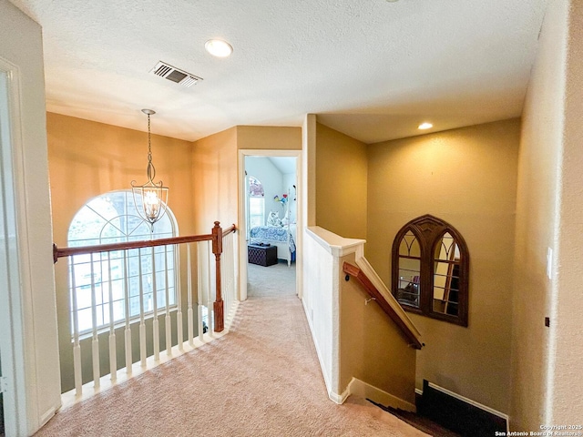 1031 Starlit Pond, San Antonio, TX 78260 - hall featuring an upstairs landing, carpet, healthy amount of natural light, a chandelier, and a textured ceiling
