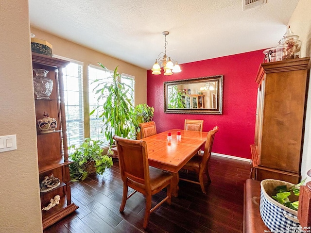 1031 Starlit Pond, San Antonio, TX 78260 - dining space featuring dark wood-style floors, a chandelier, a textured ceiling, baseboards, and a textured wall