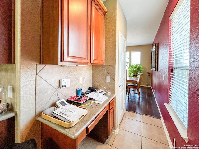 1031 Starlit Pond, San Antonio, TX 78260 - kitchen featuring light tile patterned floors, light countertops, decorative backsplash, and a textured wall