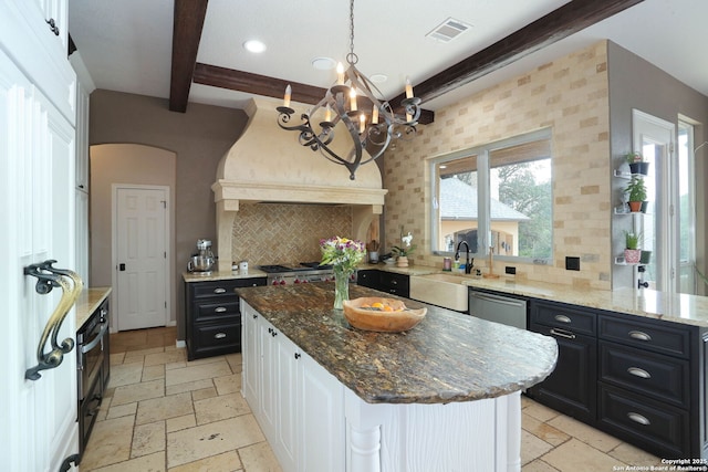 1818 Palmer Vw, San Antonio, TX 78260 - kitchen featuring beamed ceiling, stone tile flooring, tasteful backsplash, stainless steel dishwasher, and a chandelier