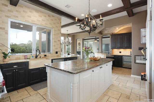 1818 Palmer Vw, San Antonio, TX 78260 - kitchen featuring a chandelier, a sink, stone tile floors, beamed ceiling, and arched walkways