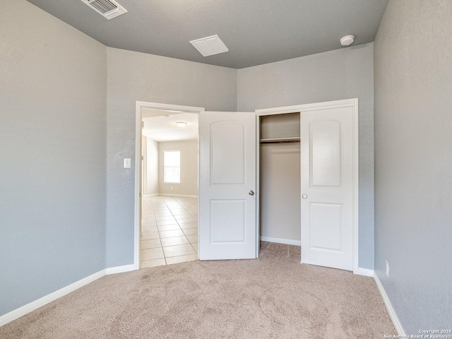 2325 Lighthouse, New Braunfels, TX 78130 - unfurnished bedroom with carpet, baseboards, a closet, and tile patterned floors