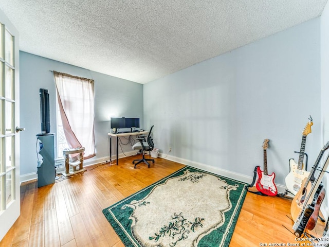 6802 S Forest Hvn, San Antonio, TX 78240 - office space featuring wood finished floors, a textured ceiling, and baseboards