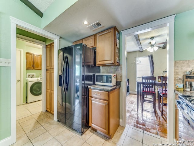 6802 S Forest Hvn, San Antonio, TX 78240 - kitchen with washer / clothes dryer, black fridge with ice dispenser, a ceiling fan, light tile patterned floors, and stainless steel stove