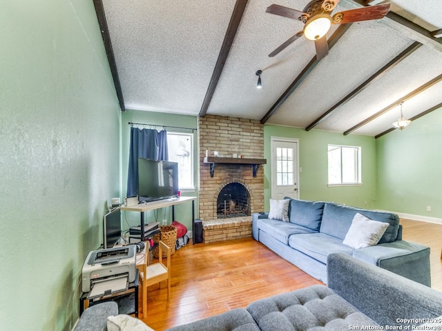 6802 S Forest Hvn, San Antonio, TX 78240 - living area featuring a textured ceiling, a brick fireplace, wood finished floors, and a ceiling fan