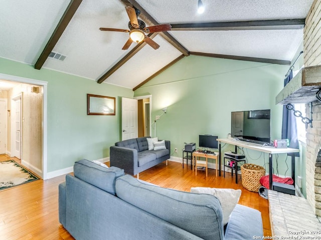 6802 S Forest Hvn, San Antonio, TX 78240 - living area with wood finished floors, ceiling fan, baseboards, a fireplace, and a textured ceiling