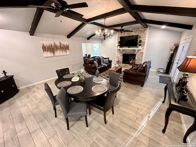 6422 Balky St, San Antonio, TX 78240 - dining room with a ceiling fan, a chandelier, light wood-style flooring, baseboards, and a stone fireplace
