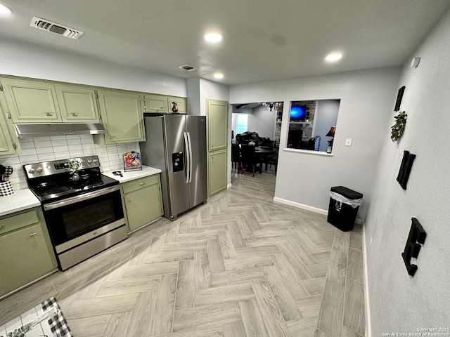 6422 Balky St, San Antonio, TX 78240 - kitchen with green cabinetry, stainless steel appliances, under cabinet range hood, baseboards, and light countertops