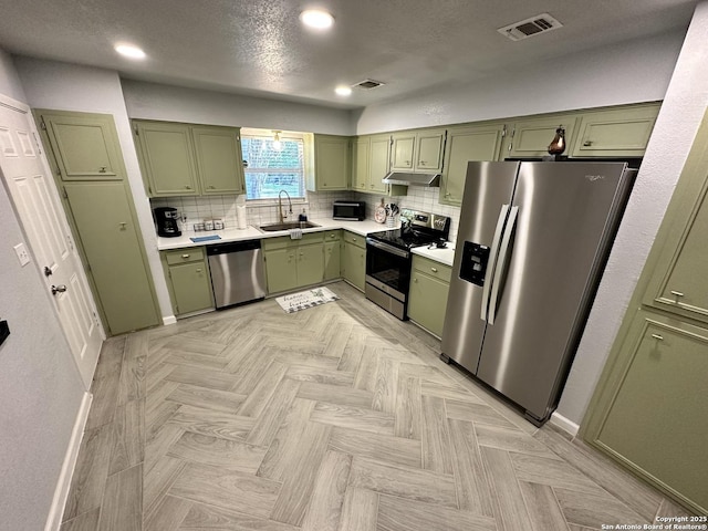 6422 Balky St, San Antonio, TX 78240 - kitchen featuring green cabinetry, appliances with stainless steel finishes, a sink, light countertops, and recessed lighting
