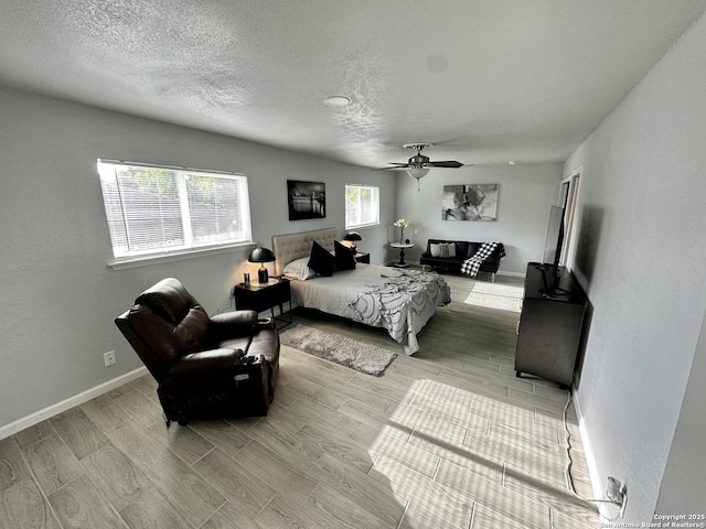 6422 Balky St, San Antonio, TX 78240 - bedroom featuring wood tiled floors, a textured ceiling, baseboards, and a ceiling fan