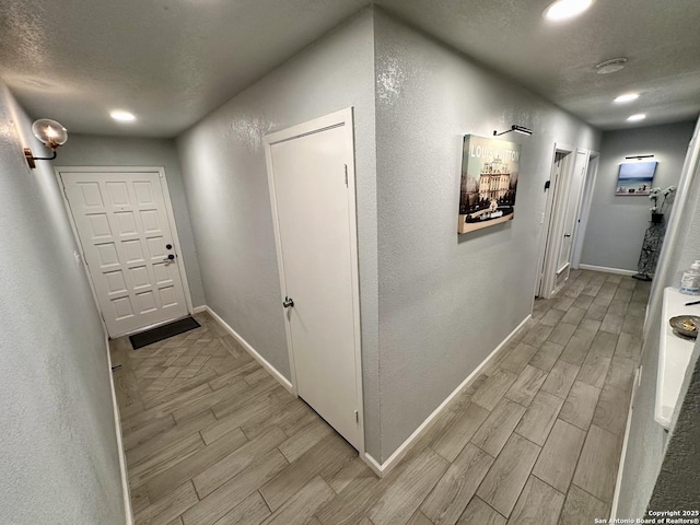 6422 Balky St, San Antonio, TX 78240 - hallway with wood tiled floors, baseboards, recessed lighting, a textured wall, and a textured ceiling