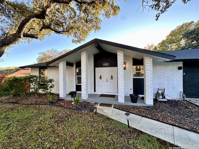 6422 Balky St, San Antonio, TX 78240 - view of exterior entry with brick siding and a porch