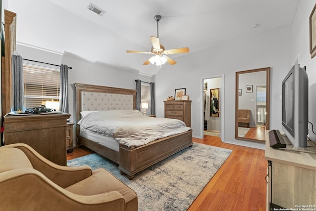 122 Rimdale, Universal City, TX 78148 - bedroom with multiple windows, light wood-style flooring, lofted ceiling, a ceiling fan, and a spacious closet