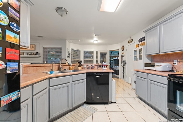 122 Rimdale, Universal City, TX 78148 - kitchen with black appliances, a sink, gray cabinetry, light tile patterned floors, and light countertops