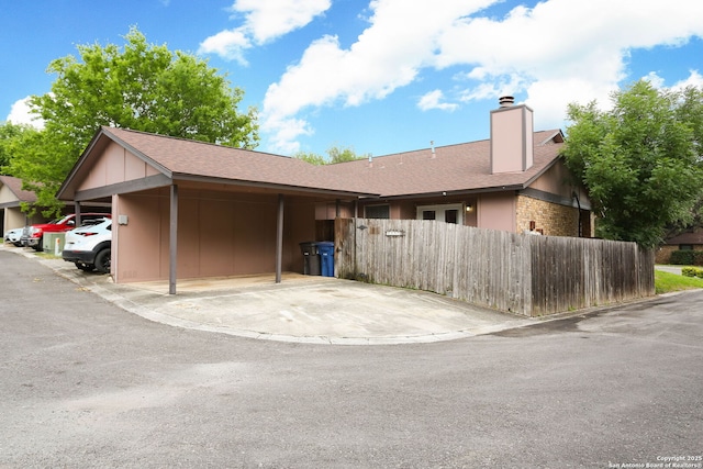 9357 Dover, San Antonio, TX 78250 - view of property exterior featuring a chimney and covered parking