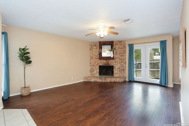 9357 Dover, San Antonio, TX 78250 - unfurnished living room featuring a ceiling fan, wood finished floors, french doors, a fireplace, and baseboards