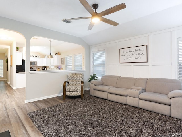 10831 Colt Chase, San Antonio, TX 78254 - living room with lofted ceiling, a ceiling fan, light wood finished floors, healthy amount of natural light, and arched walkways