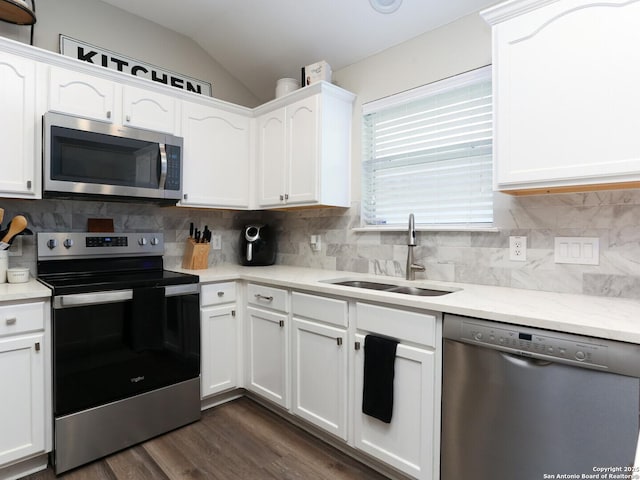 10831 Colt Chase, San Antonio, TX 78254 - kitchen featuring stainless steel appliances, a sink, white cabinets, dark wood-style flooring, and lofted ceiling
