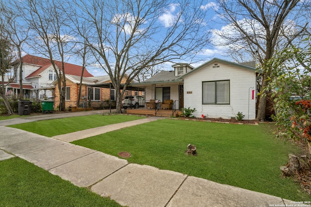 1119 N Pine St, San Antonio, TX 78202 - view of front facade with covered porch, a front lawn, and brick siding