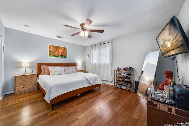 1119 N Pine St, San Antonio, TX 78202 - bedroom featuring wood-type flooring, a ceiling fan, and baseboards