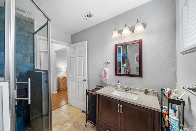 1119 N Pine St, San Antonio, TX 78202 - bathroom with vanity, a stall shower, and tile patterned floors