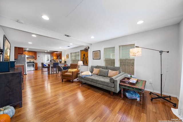 1119 N Pine St, San Antonio, TX 78202 - living room featuring light wood finished floors, recessed lighting, and baseboards