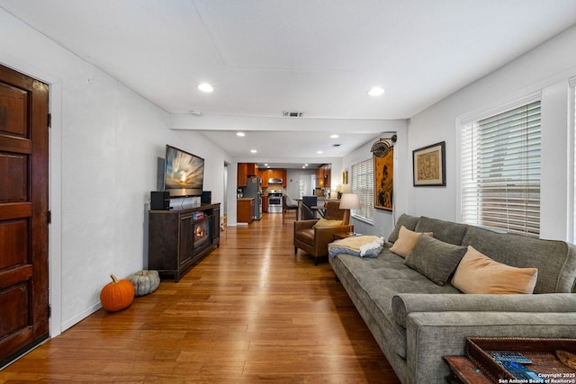 1119 N Pine St, San Antonio, TX 78202 - living area with wood finished floors, a fireplace, and recessed lighting