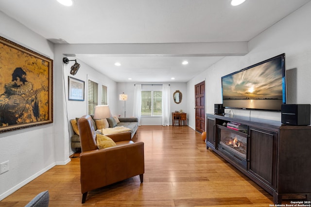1119 N Pine St, San Antonio, TX 78202 - living area featuring baseboards, recessed lighting, light wood-style floors, and a glass covered fireplace