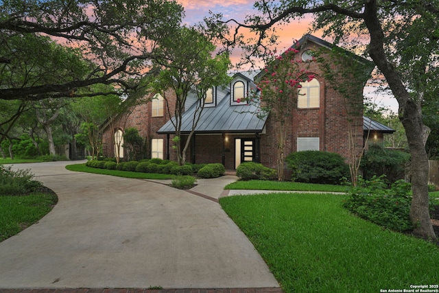 21641 Forest Waters, Garden Ridge, TX 78266 - view of front of home with a standing seam roof, brick siding, a lawn, and metal roof