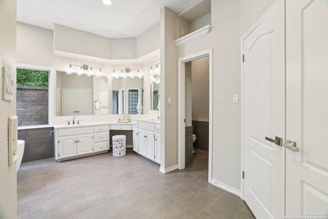 21641 Forest Waters, Garden Ridge, TX 78266 - bathroom featuring double vanity, a freestanding tub, toilet, and tile patterned floors