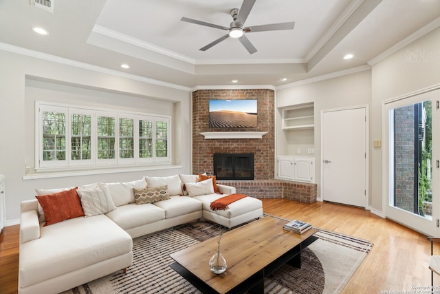 21641 Forest Waters, Garden Ridge, TX 78266 - living area with wood finished floors, a raised ceiling, ceiling fan, built in features, and ornamental molding