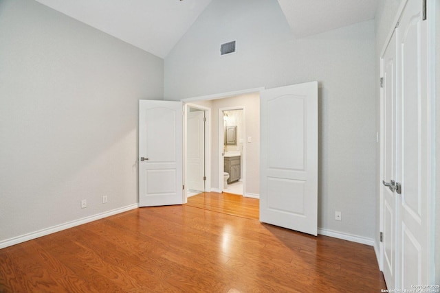 21641 Forest Waters, Garden Ridge, TX 78266 - unfurnished bedroom with high vaulted ceiling, baseboards, and wood finished floors