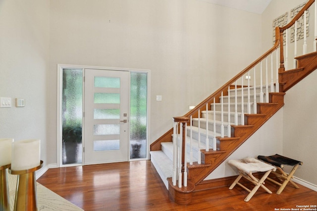 21641 Forest Waters, Garden Ridge, TX 78266 - foyer featuring wood finished floors, a towering ceiling, stairs, and baseboards