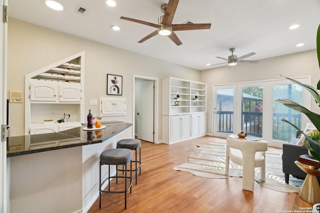 21641 Forest Waters, Garden Ridge, TX 78266 - kitchen featuring ceiling fan, a kitchen breakfast bar, light wood finished floors, white cabinets, and recessed lighting