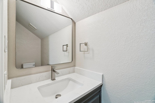 21641 Forest Waters, Garden Ridge, TX 78266 - bathroom with lofted ceiling, a textured wall, vanity, toilet, and a textured ceiling