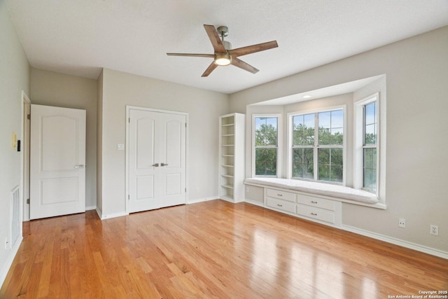 21641 Forest Waters, Garden Ridge, TX 78266 - unfurnished bedroom featuring light wood-type flooring, baseboards, and a ceiling fan