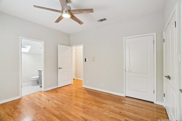 21641 Forest Waters, Garden Ridge, TX 78266 - unfurnished bedroom with light wood-type flooring, a skylight, connected bathroom, baseboards, and a ceiling fan