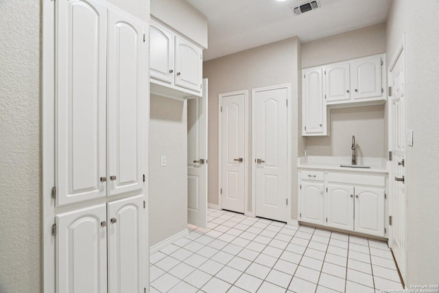 21641 Forest Waters, Garden Ridge, TX 78266 - kitchen featuring a sink, white cabinetry, light tile patterned floors, and light countertops