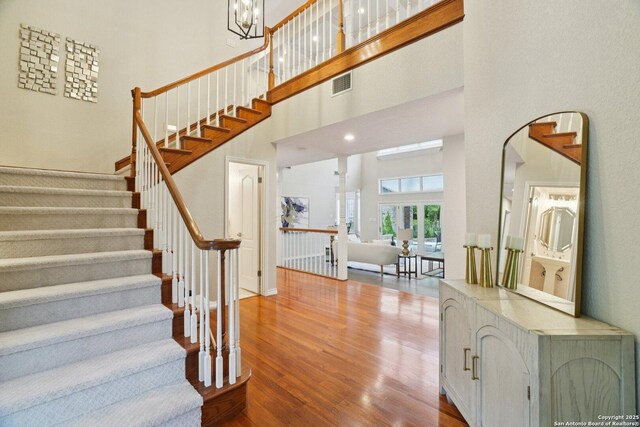 21641 Forest Waters, Garden Ridge, TX 78266 - stairway with wood finished floors, a high ceiling, and arched walkways