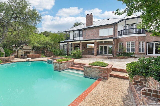 21641 Forest Waters, Garden Ridge, TX 78266 - back of house featuring brick siding, a patio area, a balcony, a chimney, and outdoor lounge area