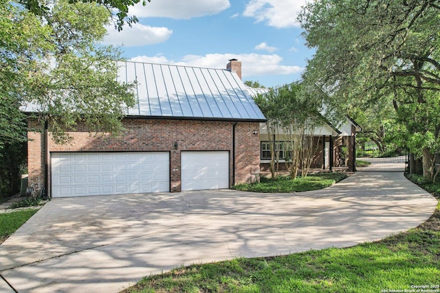 21641 Forest Waters, Garden Ridge, TX 78266 - view of property exterior featuring brick siding, a chimney, a standing seam roof, driveway, and metal roof