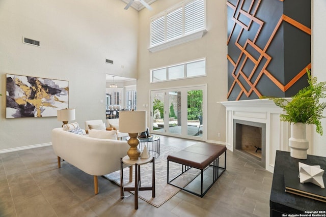 21641 Forest Waters, Garden Ridge, TX 78266 - living area featuring a high ceiling, baseboards, a fireplace, and french doors
