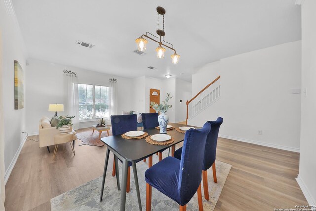 11502 Windwalk, San Antonio, TX 78253 - dining area with baseboards, light wood finished floors, and stairs