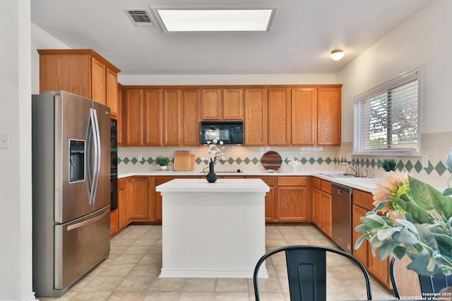 11502 Windwalk, San Antonio, TX 78253 - kitchen with appliances with stainless steel finishes, a sink, brown cabinets, light countertops, and a center island