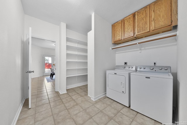 11502 Windwalk, San Antonio, TX 78253 - laundry room with cabinet space, washer and clothes dryer, baseboards, light tile patterned flooring, and a textured ceiling