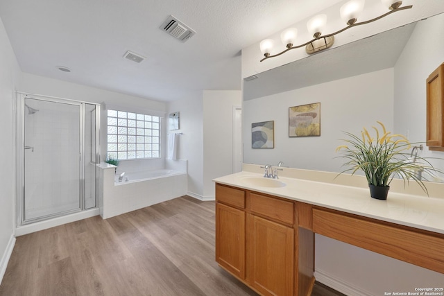 11502 Windwalk, San Antonio, TX 78253 - full bath featuring a garden tub, vanity, wood finished floors, and a stall shower