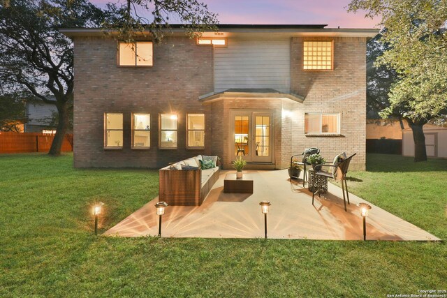 11502 Windwalk, San Antonio, TX 78253 - back of property at dusk with an outdoor living space, brick siding, and a patio