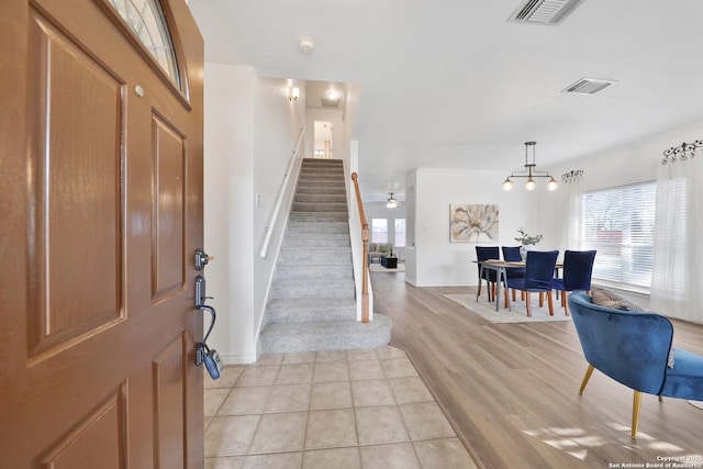 11502 Windwalk, San Antonio, TX 78253 - foyer entrance with stairway, baseboards, light tile patterned floors, and a chandelier