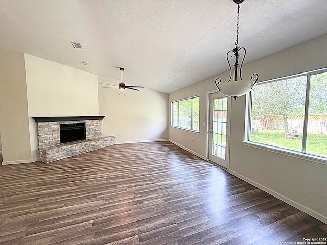 14663 Hillside Rdg, San Antonio, TX 78233 - unfurnished living room with dark wood-type flooring, ceiling fan, lofted ceiling, baseboards, and a textured ceiling