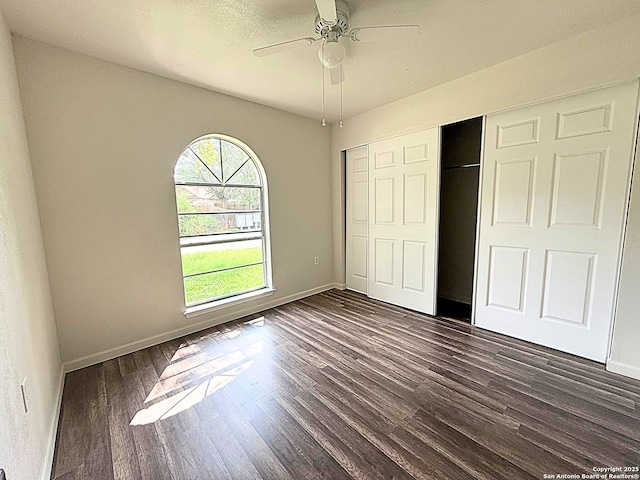 14663 Hillside Rdg, San Antonio, TX 78233 - unfurnished bedroom featuring dark wood-type flooring, baseboards, a closet, and ceiling fan